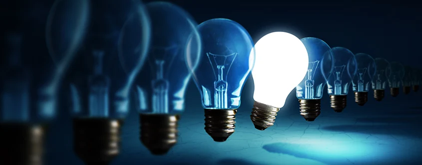 on lightbulb standing out in a line of lightbulbs