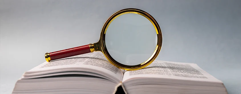 magnifying glass on top of a book